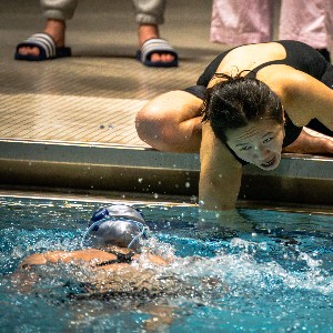 Team mate encouraging a swimmer in the water